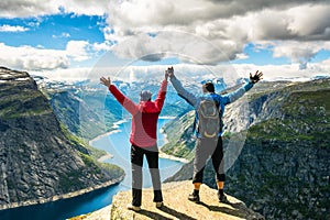 Couple standing against amazing nature view on the way to Trolltunga. Location: Scandinavian Mountains, Norway, Stavanger. Artist photo