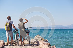 Couple standing on a bridge with bicycles