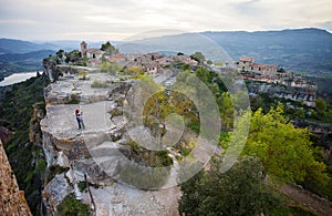 Couple standing on cliff near old village Siurana