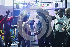 Couple standing on crowded dancefloor