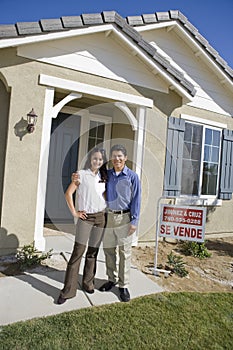 Couple Standing In Front Of New House