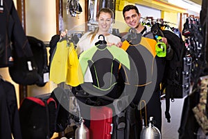 Couple standing with full set equipment for diving