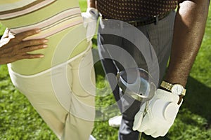 Couple Standing With Golf Club