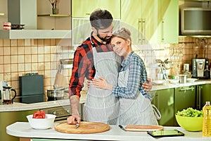 Couple standing in the kitchen.