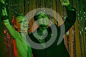 Couple standing in lively rave setting