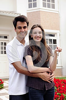 Couple standing outside new house