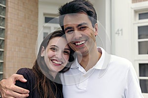 Couple standing outside new house