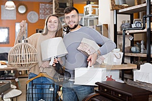 couple standing with purchases in furnishings showroom