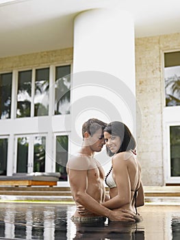 Couple Standing In Swimming Pool