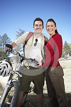 Couple Standing Together With Bicycle