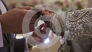 Couple standing together dressed in traditional clothes, hindu wedding. Close up view of couples