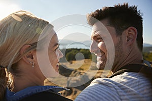 Couple Standing At Top Of Hill On Hike Through Countryside In Lake District UK