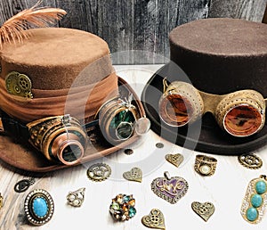 couple steampunk hats, with googles, gears, magnifiers, feather