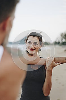 Couple stretching at the beach