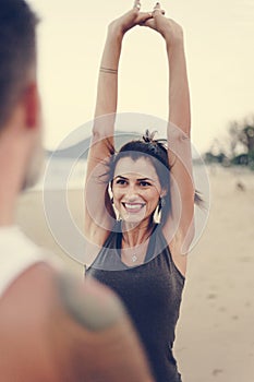 Couple stretching at the beach