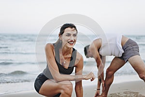 Couple stretching at the beach