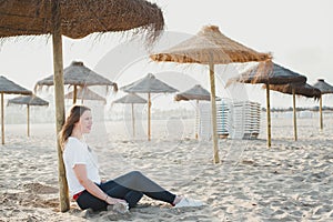 Couple strolling calmly on the warm beach umbrellas