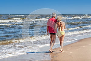 Couple strolling at coastline photo