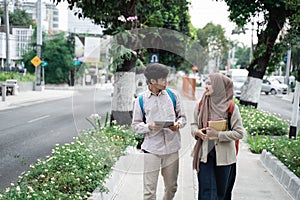 Couple student chatting while walk to campus