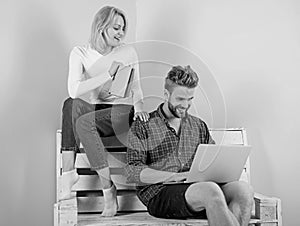 Couple students with book and laptop studying. Modern students use digital approach instead outdated. Man and woman use