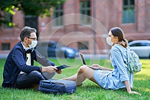 Couple of students in the campus wearing masks due to coronavirus pandemic