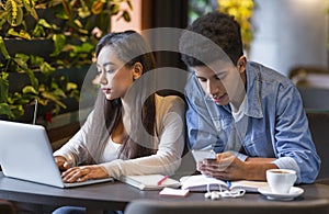 Couple of students using technologies in studying