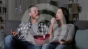 Couple suffering a blackout watching tv