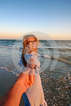 Couple summer vacation travel - Woman walking on romantic honeymoon beach holidays holding hand of boyfriend following her