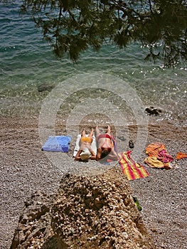 Couple sunbathing on beach