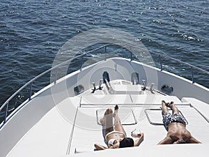 Couple Sunbathing On Yacht