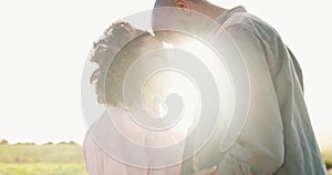 Couple, sunlight and forehead touch in nature for bonding together, love and happy in marriage. Interracial people