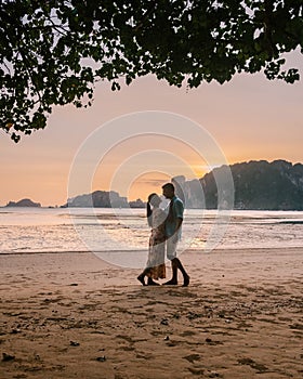 Couple during sunset on the beach Krabi Thailand, men and woman watching sunset at Ao Nam Mao beach Krabi Ao Nang area
