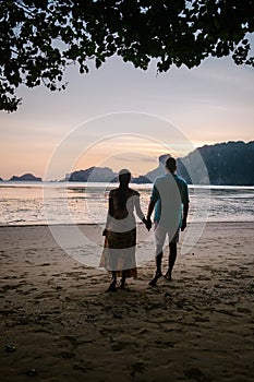 Couple during sunset on the beach Krabi Thailand, men and woman watching sunset at Ao Nam Mao beach Krabi Ao Nang area