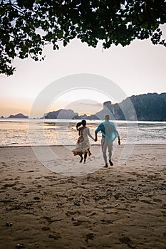 Couple during sunset on the beach Krabi Thailand, men and woman watching sunset at Ao Nam Mao beach Krabi Ao Nang area