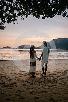 Couple during sunset on the beach Krabi Thailand, men and woman watching sunset at Ao Nam Mao beach Krabi Ao Nang area