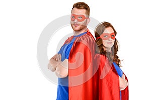 couple of superheroes in costumes standing with crossed arms and looking at camera