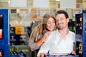 Couple in supermarket buying beverages