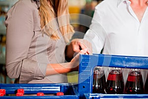 Couple in supermarket buying beverages