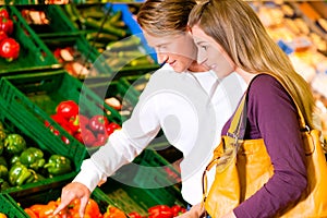 Couple in supermarket shopping groceries