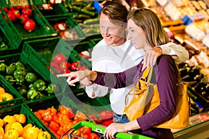 Couple in supermarket shopping groceries