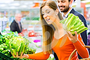 Couple in supermarket shopping groceries