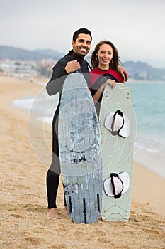 Couple with surf boards on the beach