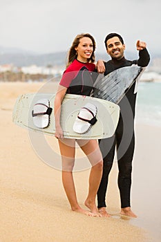 Couple with surf boards on the beach
