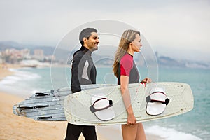 Couple with surf boards on the beach