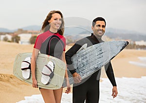 Couple with surf boards on the beach