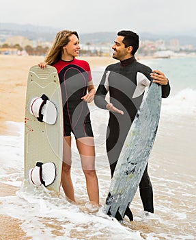 Couple with surf boards on the beach