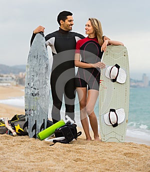 Couple with surf boards on the beach