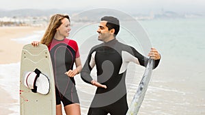 Couple with surf boards on the beach