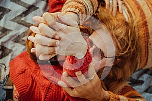 Couple in sweaters chilling and hugging on blanket outdoors in