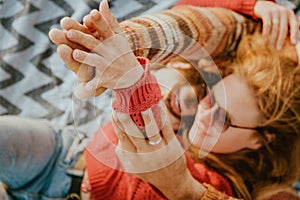 Couple in sweaters chilling and hugging on blanket outdoors in